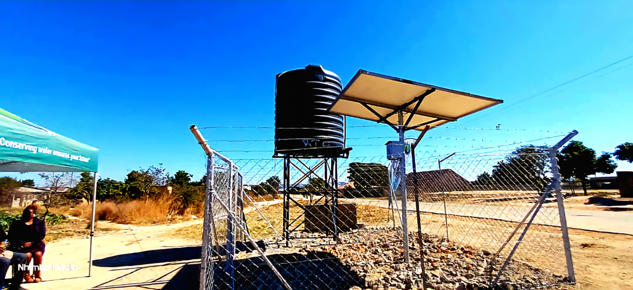 Solar-powered borehole water tank and panels at Magamba